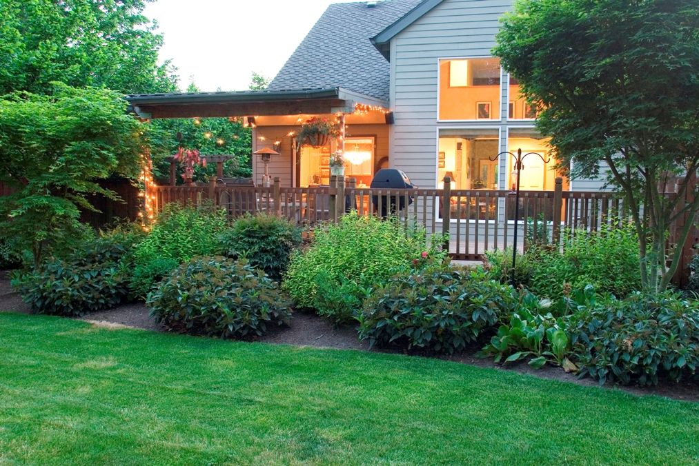 house exterior with lights on seen from lawn