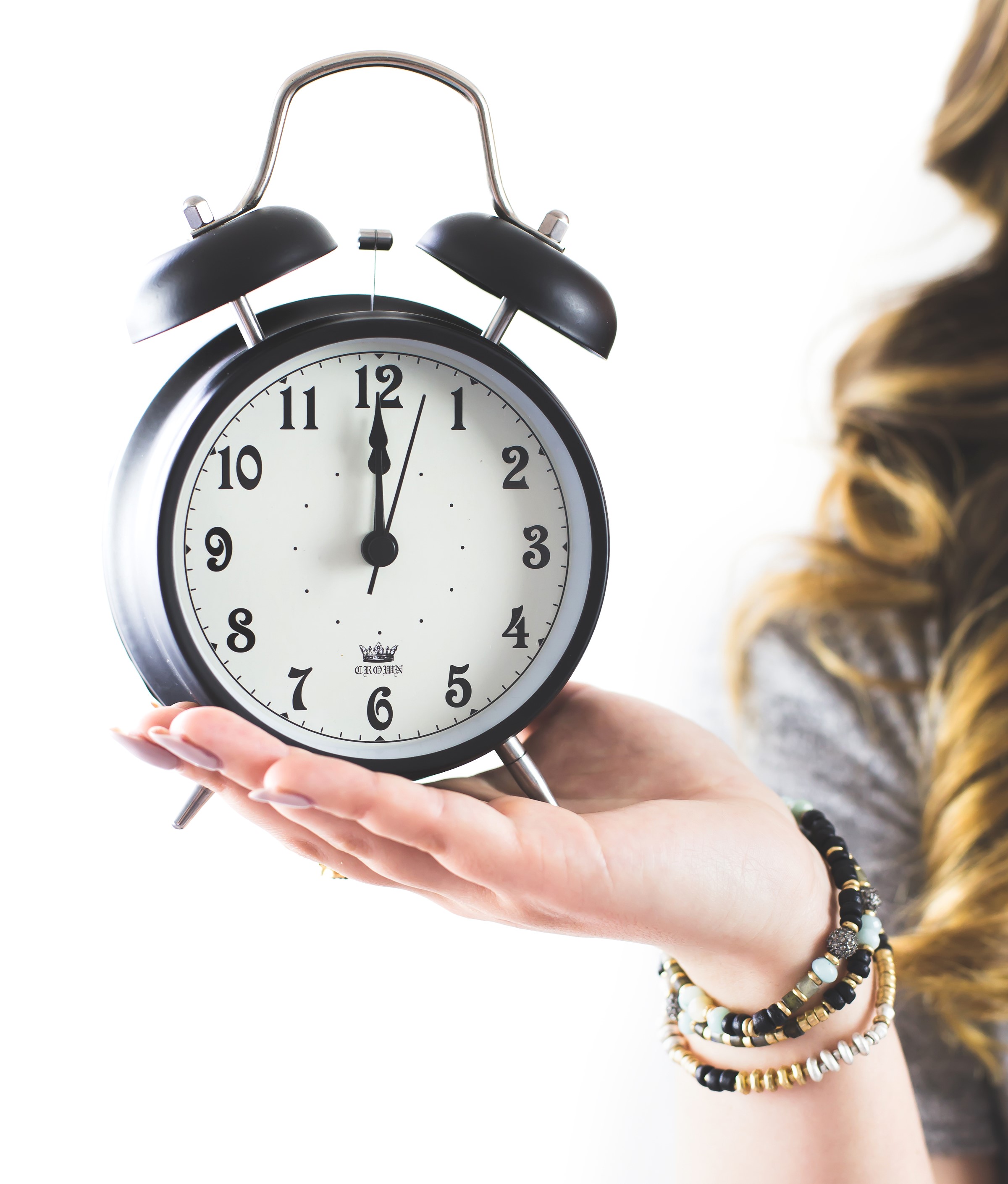 hand holding alarm clock