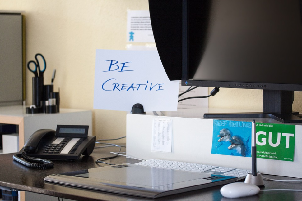 office desk computer monitor phone keyboard be creative sign