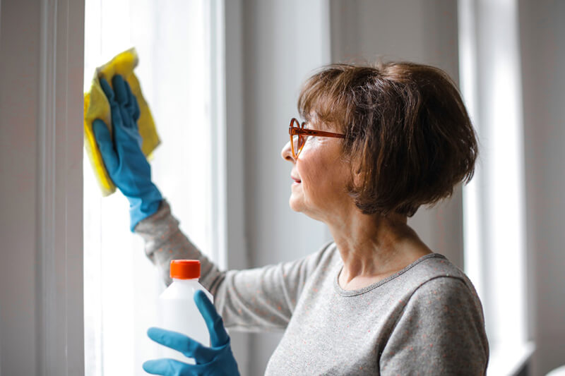 Cleaning Your House woman cleaning home with disinfectant