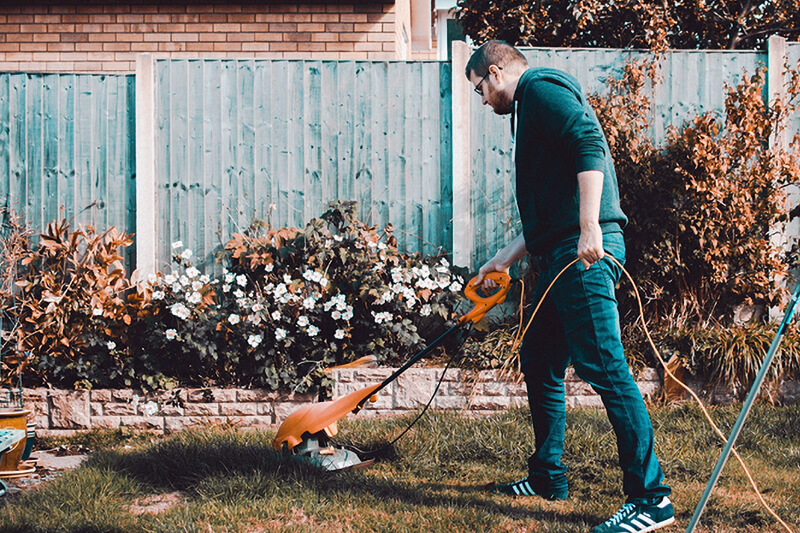 Lawn Cleaning man mowing grass on lawn